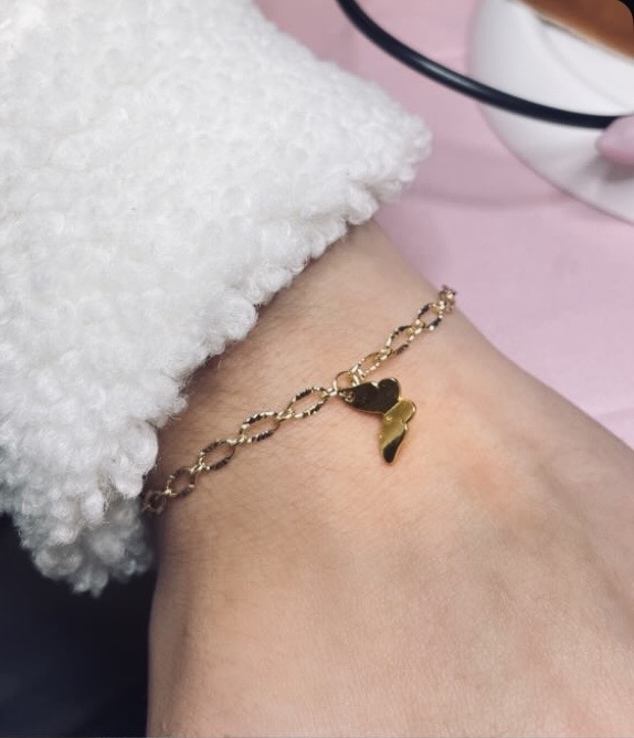 Gold chain bracelet with heart and wing charm
